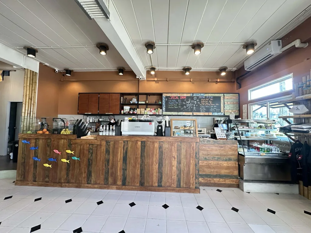Interior of Wilson’s Cafe Phuket Town new opening on Bangkok Road showing wooden counter, coffee bar and display case